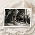 Example print: black and white photo of a grandmother and granddaughter baking together, printed on Hahnemühle FineArt Baryta 325g