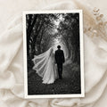Example print: black and white wedding photo of a bride and groom walking down a tree-lined path, printed on Hahnemühle FineArt Baryta Satin 300g
