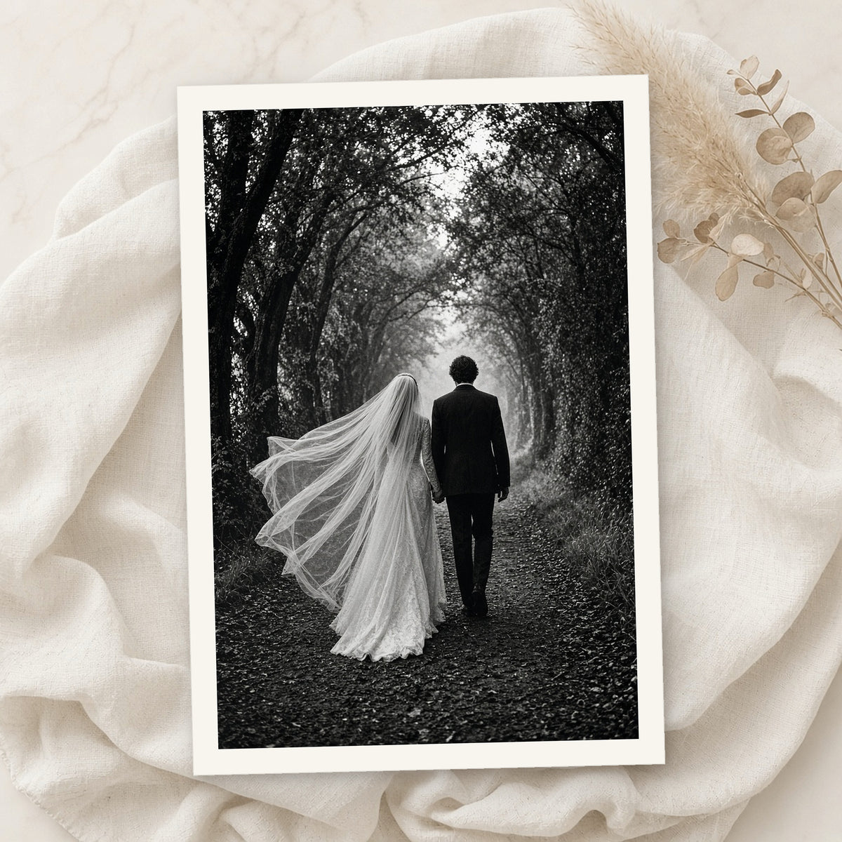 Example print: black and white wedding photo of a bride and groom walking down a tree-lined path, printed on Hahnemühle FineArt Baryta Satin 300g