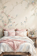Blossom Bedroom Sanctuary — a cottage bedroom with delicate floral vines on the wall, layered white bedding, blush and sage pillows and a bouquet