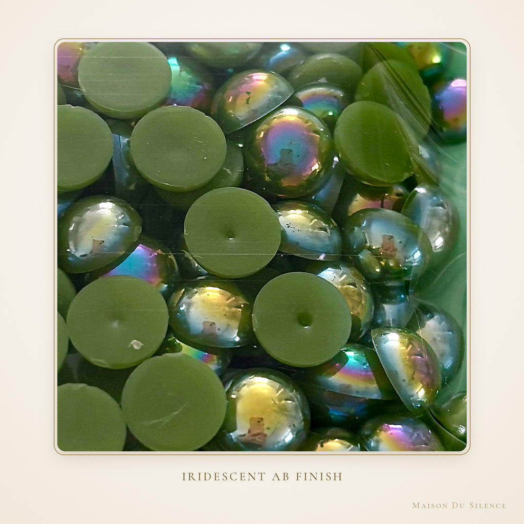 Close-up of peridot green 10 mm half pearls with an iridescent AB shimmer