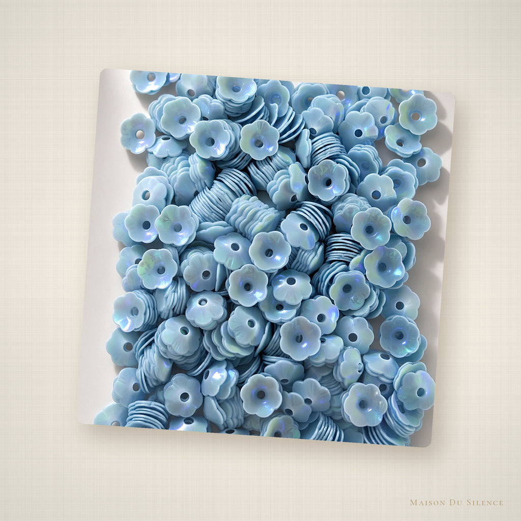 Blue flower sequins styled on an ivory linen backdrop