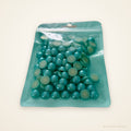 Bag of aquamarine half pearls, 12 mm, 60g