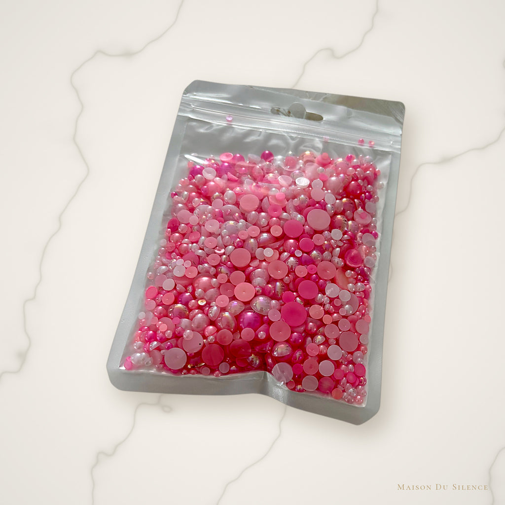 Pink half pearls styled on an ivory marble backdrop