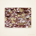Close-up of Rose Lumière pink SS10 faceted flatback glass rhinestones on an ivory background